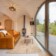 Revonia underground house interior with glass garden doors – arched vault living room opening to outdoor terrace and forest