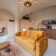 Revonia underground house interior panorama – connected arched vault rooms showing living room, kitchen and lounge in modular earth home