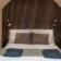 Revonia underground house luxury bedroom – double bed with wooden slat feature wall under arched vault ceiling in modular earth home