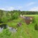 Aerial view of Riverberg vacation estate in Otepää with Revonia underground earth houses, pond and forest