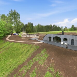 Revonia underground vault house under construction – aerial view of arched prefab modules being installed at Riverberg estate, Otepää